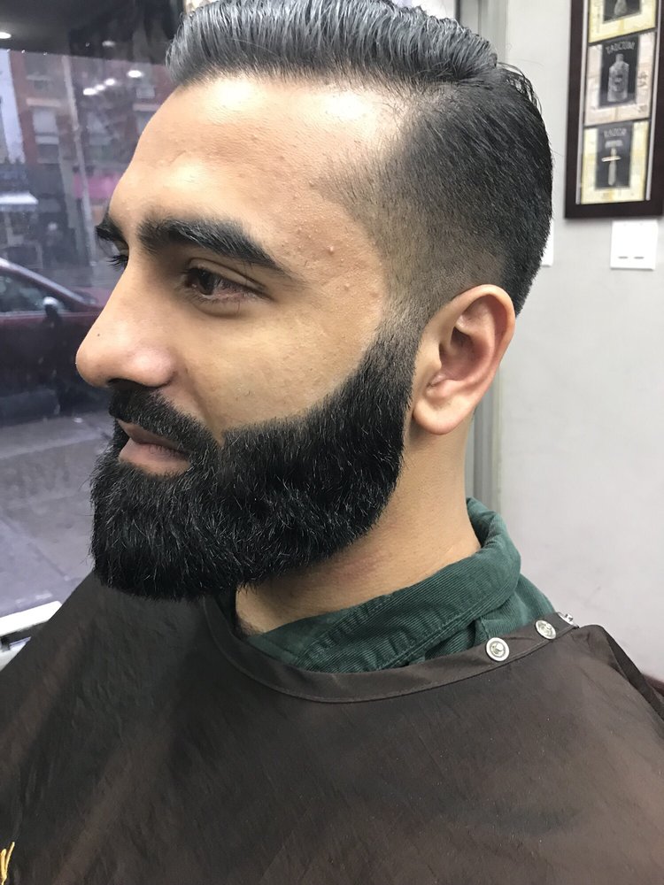 Client with a sharp pompadour and shaped full beard