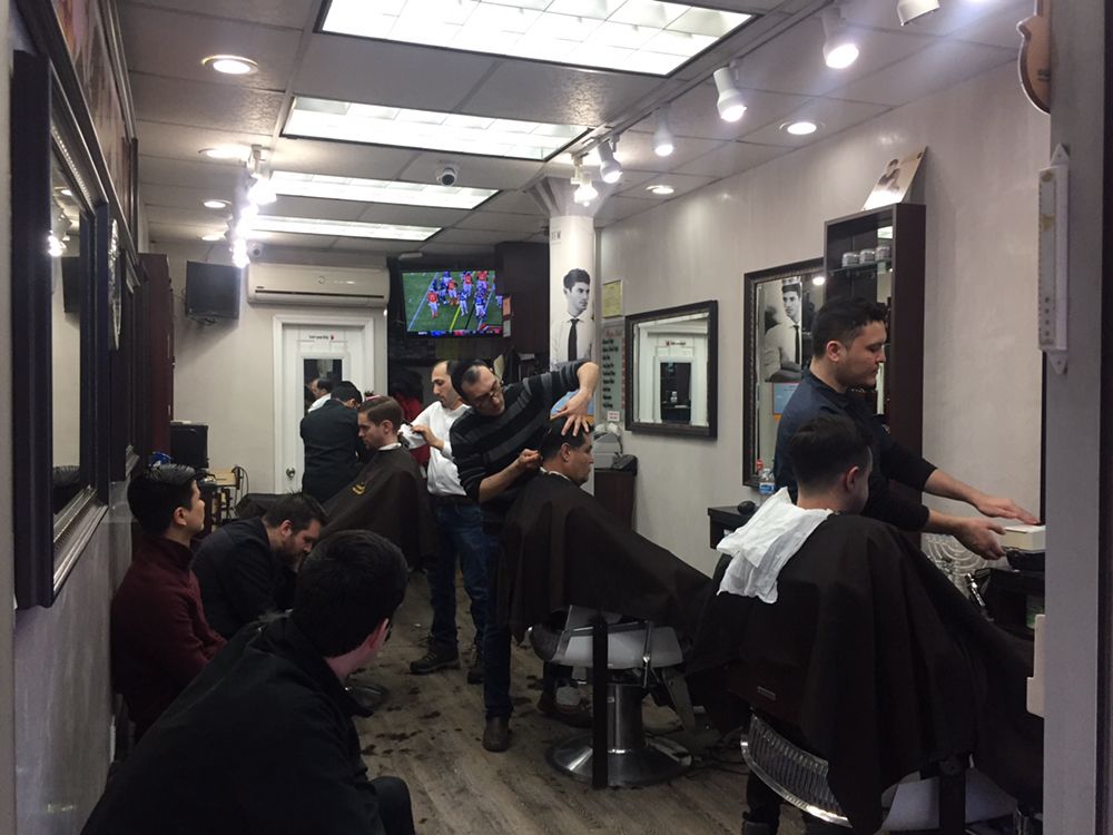 Barbers working with clients on the floor at Level Two Barbershop