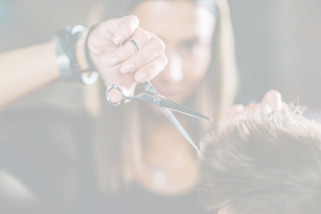 Barber styling a client with scissors