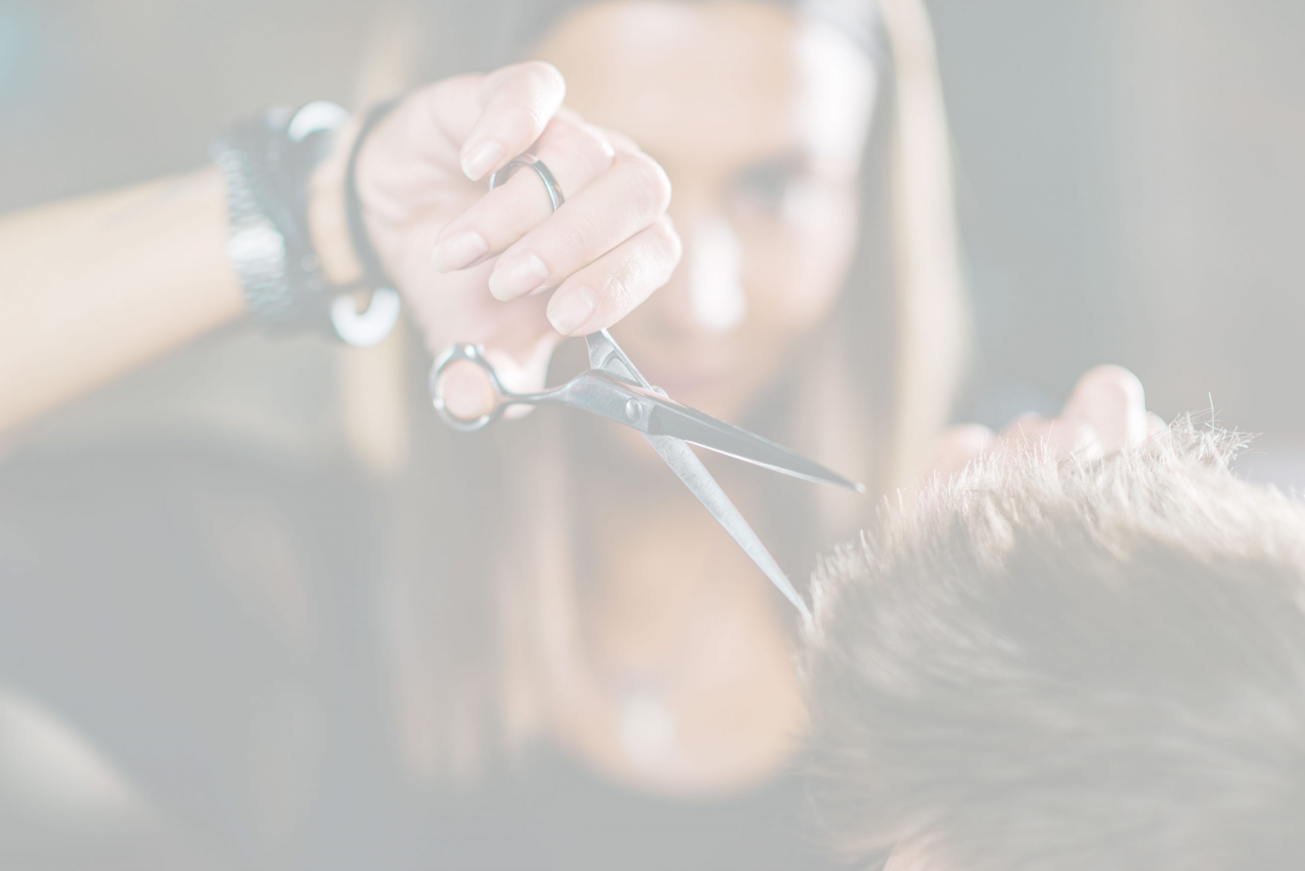 Barber styling a client with scissors